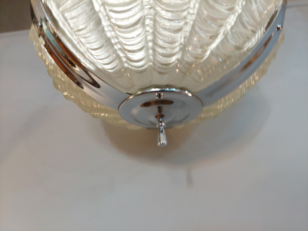 An Art Deco ceiling light fixture featuring three cream frosted glass clam shell shades held together by chrome brackets and suspended by three metal chains. View II