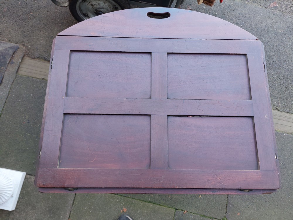 An early 19th-century Cuban mahogany oval butlers tray with hinged folding sides, brass fittings, and a turned X-frame stand. View VIII