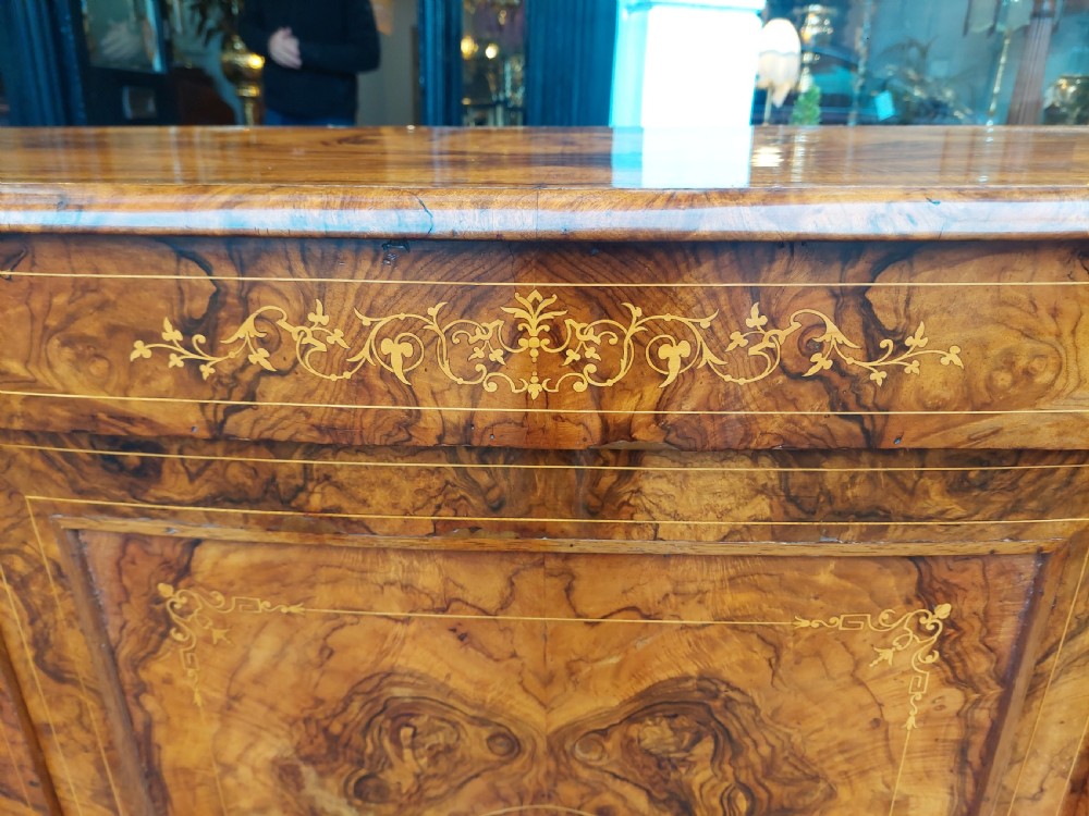 A Victorian burr walnut bow-fronted credenza featuring central inlaid wooden doors flanked by curved glazed display sections with ormolu mounts. View III