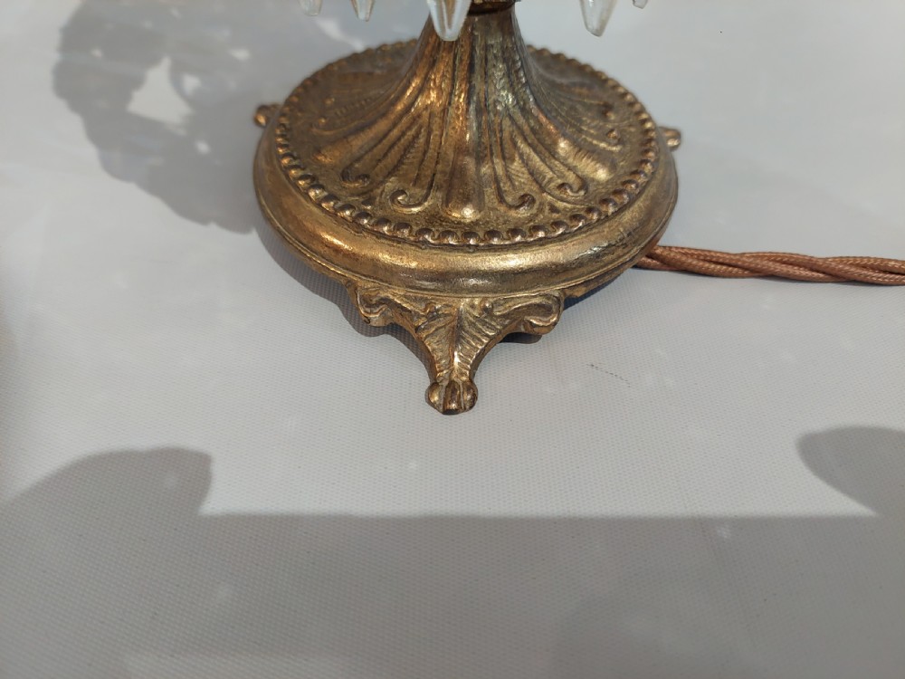 A pair of early 20th-century French style gilt brass table lustres featuring tiered strands of crystal beads and cascading prism drops. View III