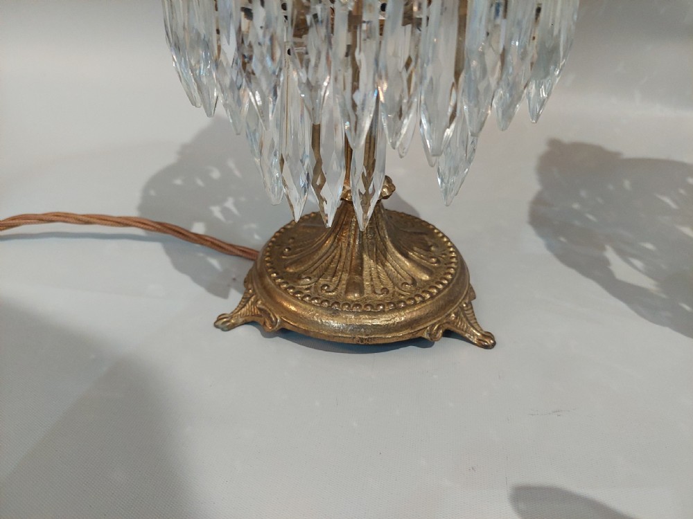 A pair of early 20th-century French style gilt brass table lustres featuring tiered strands of crystal beads and cascading prism drops. View IV