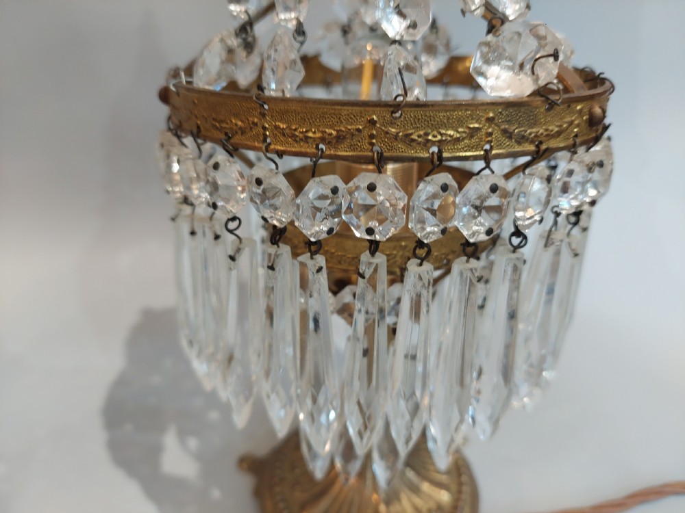 A pair of early 20th-century French style gilt brass table lustres featuring tiered strands of crystal beads and cascading prism drops. View VIII