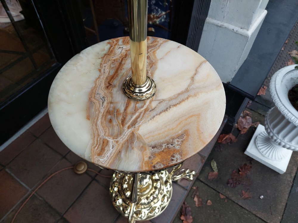 A late Victorian Art Nouveau brass standard lamp featuring an integrated marble tray, ornate curved legs, and a cream fringed lampshade. View V