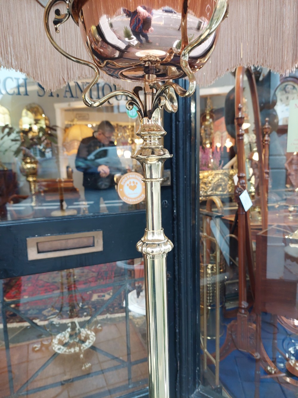 A late Victorian Art Nouveau brass standard lamp featuring an integrated marble tray, ornate curved legs, and a cream fringed lampshade. View VI