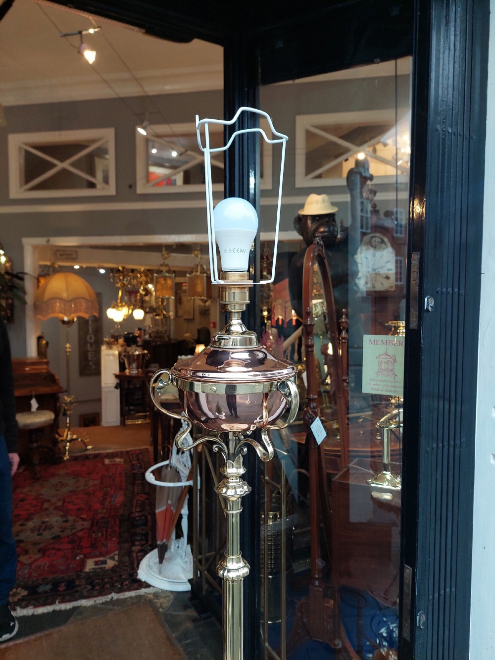 A late Victorian Art Nouveau brass standard lamp featuring an integrated marble tray, ornate curved legs, and a cream fringed lampshade. View VII