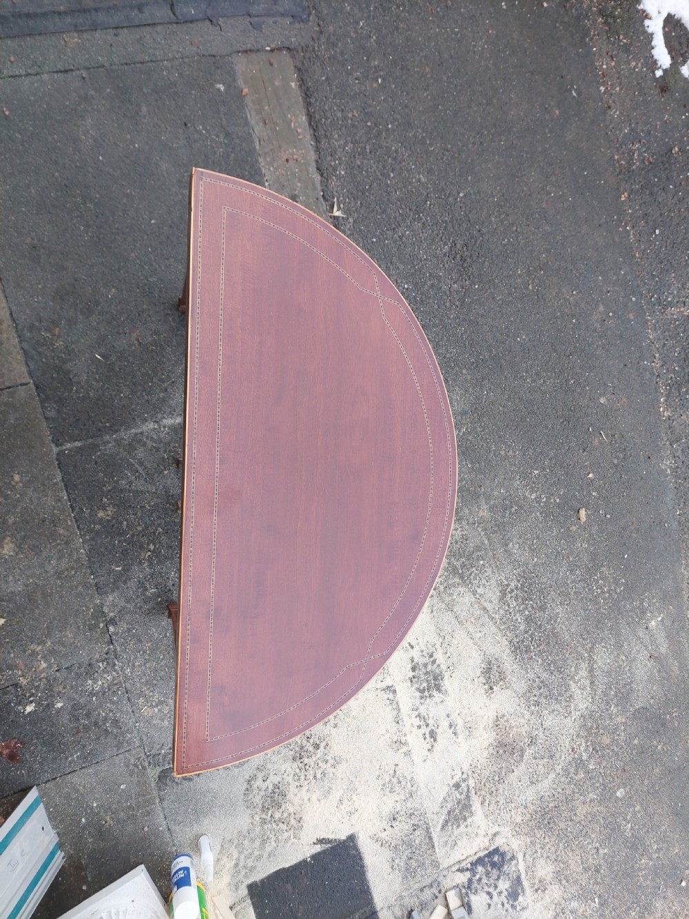 An Edwardian demilune card table crafted from mahogany with fine boxwood stringing and square tapered legs. View III
