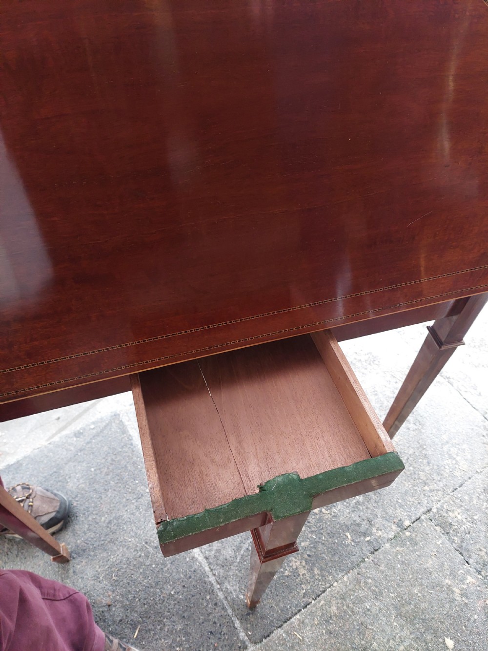 An Edwardian demilune card table crafted from mahogany with fine boxwood stringing and square tapered legs. View IV