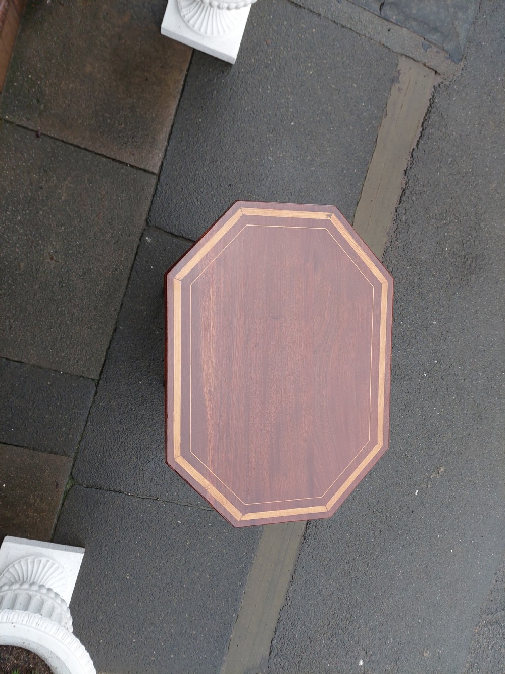 An Edwardian octagonal mahogany occasional table featuring inlaid satinwood borders, pierced side fretwork panels, and a lower tier supported by tapered square legs. View II