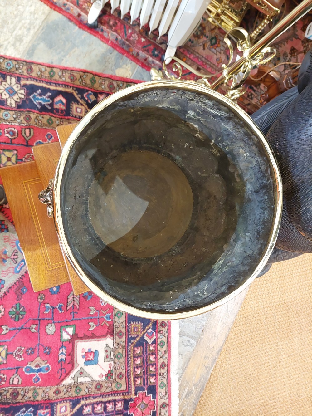 A round Victorian metal log bucket featuring embossed heraldic crests, lion mask ring handles, and gadrooned relief work. View VI