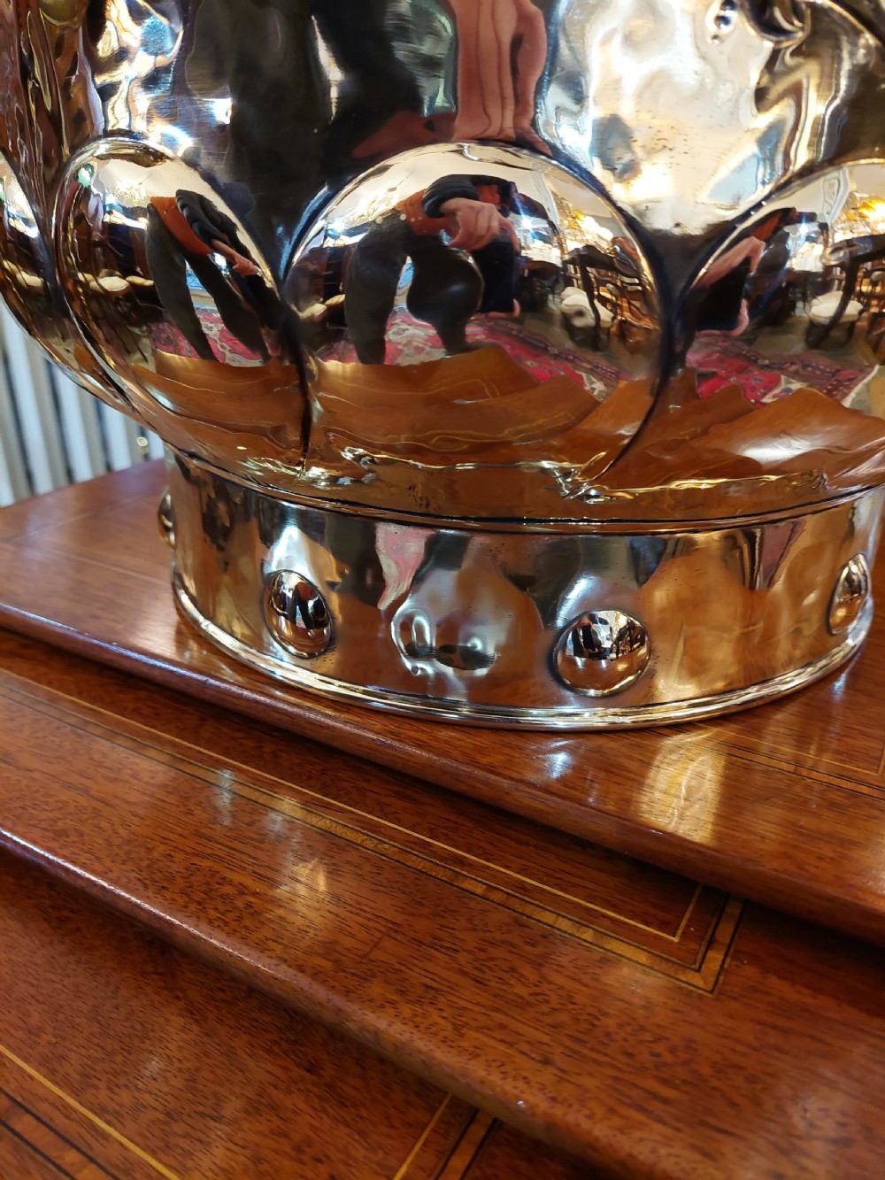 A round Victorian metal log bucket featuring embossed heraldic crests, lion mask ring handles, and gadrooned relief work. View VIII