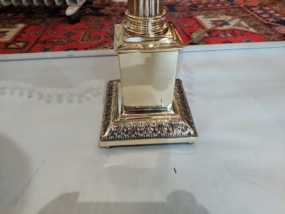 A brass column table lamp featuring a reeded stem, stepped square base, and a cream fabric dome shade trimmed with dark braid and clear glass droplet fringe. View II