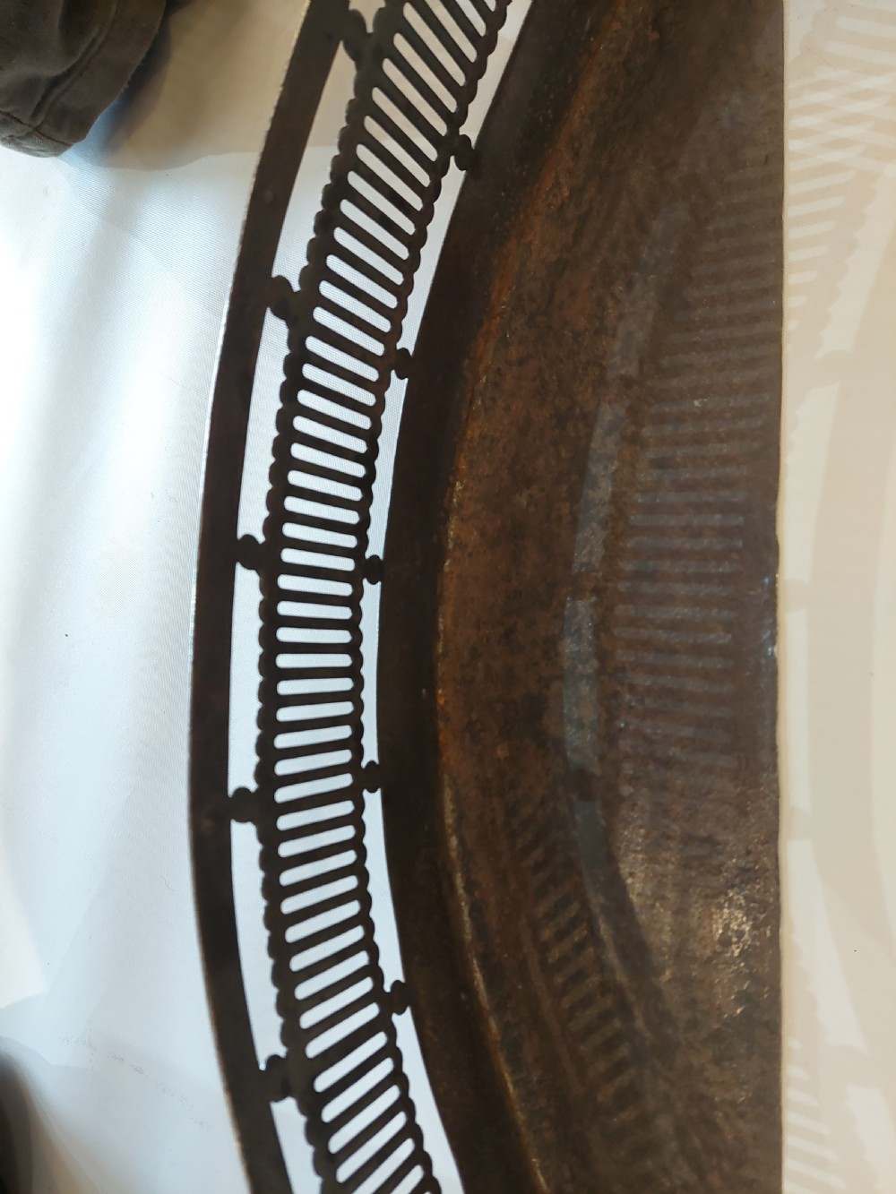 A Georgian serpentine polished steel fire fender featuring pierced fretwork detail along the front curve. View VII