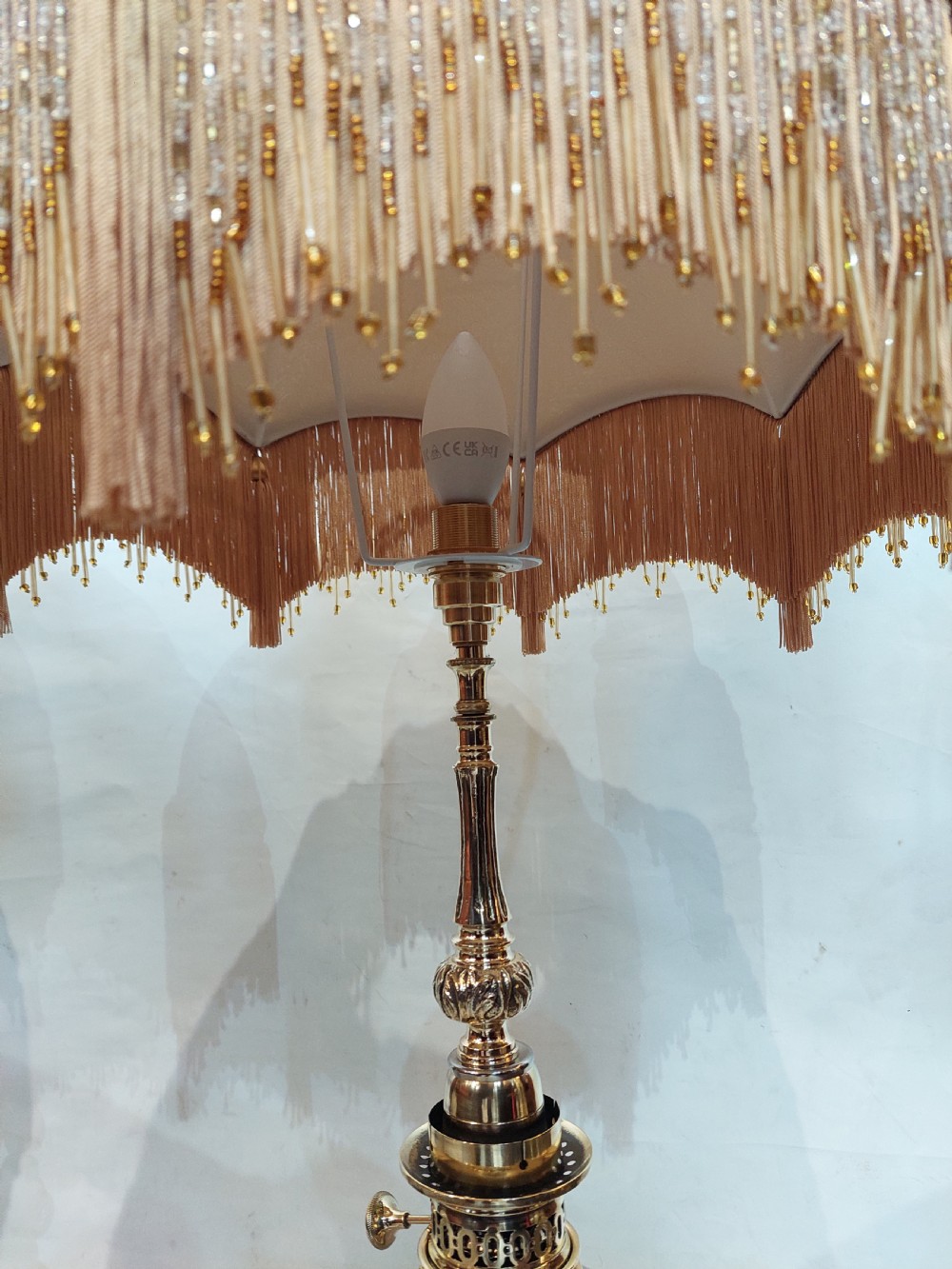 A pair of late 19th-century gilt brass and grey porcelain table lamps featuring fringed fabric lampshades. View III