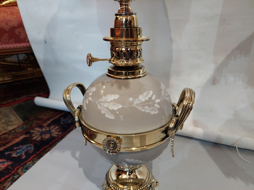 A pair of late 19th-century gilt brass and grey porcelain table lamps featuring fringed fabric lampshades. View IV