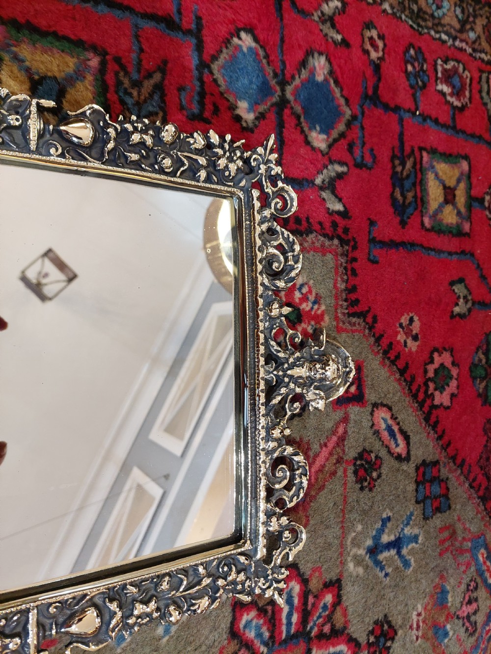 An ornate late Victorian rectangular wall mirror featuring a heavily detailed cast brass frame decorated with scrolls, floral motifs, and a crest detail at the top. View II