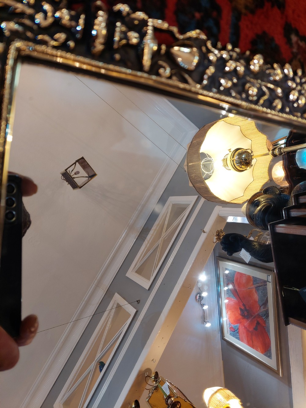An ornate late Victorian rectangular wall mirror featuring a heavily detailed cast brass frame decorated with scrolls, floral motifs, and a crest detail at the top. View V