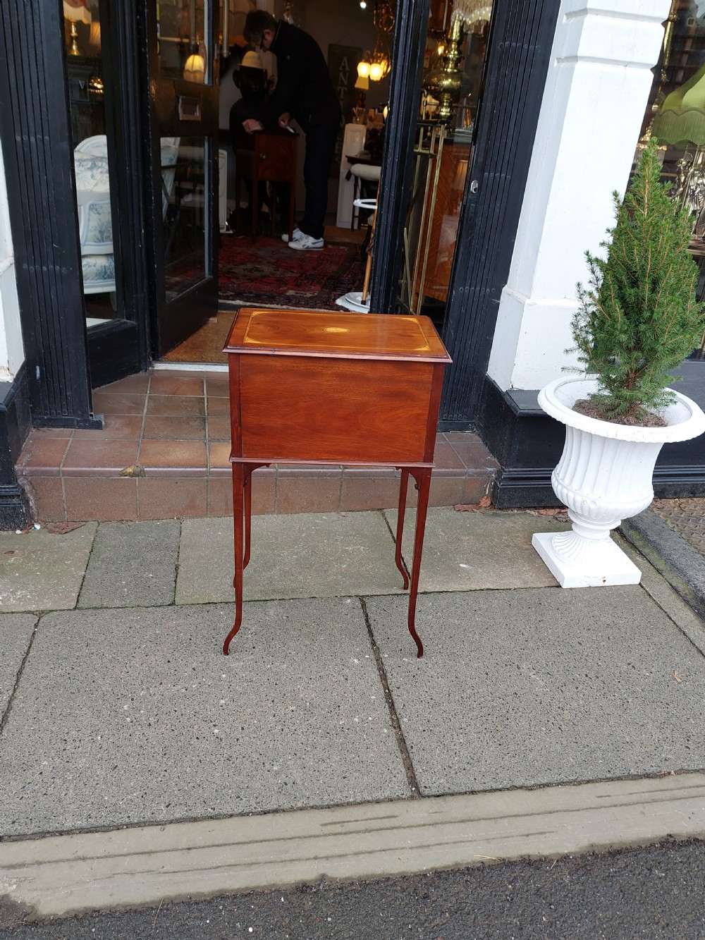 An Edwardian mahogany work table featuring satinwood line inlay and central shell marquetry motifs, elevated on slender splayed legs. View III