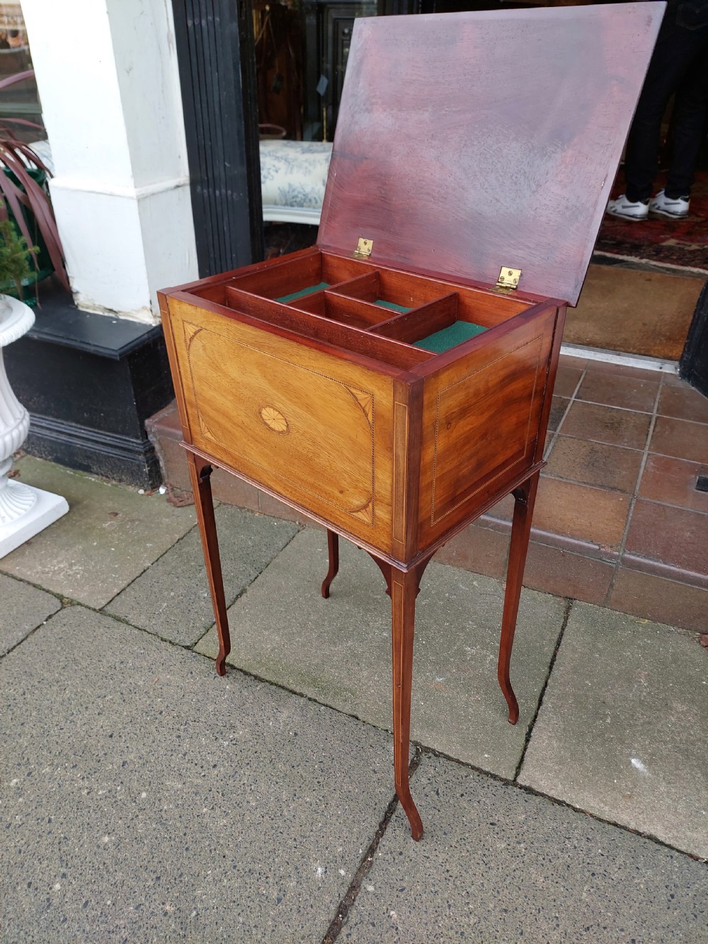 An Edwardian mahogany work table featuring satinwood line inlay and central shell marquetry motifs, elevated on slender splayed legs. View V