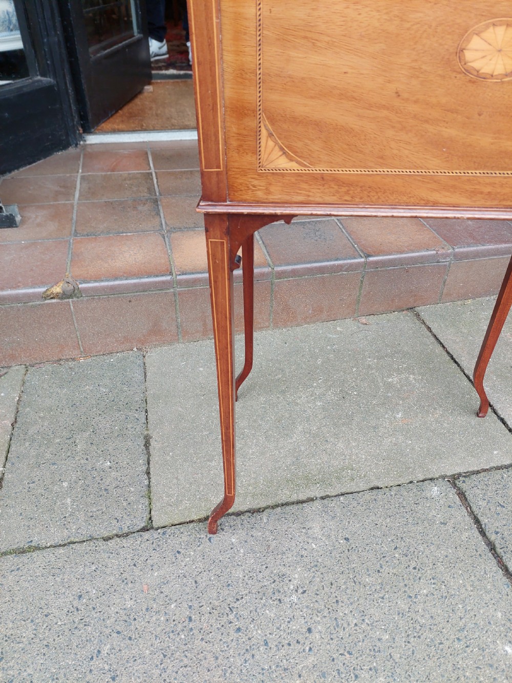 An Edwardian mahogany work table featuring satinwood line inlay and central shell marquetry motifs, elevated on slender splayed legs. View VI