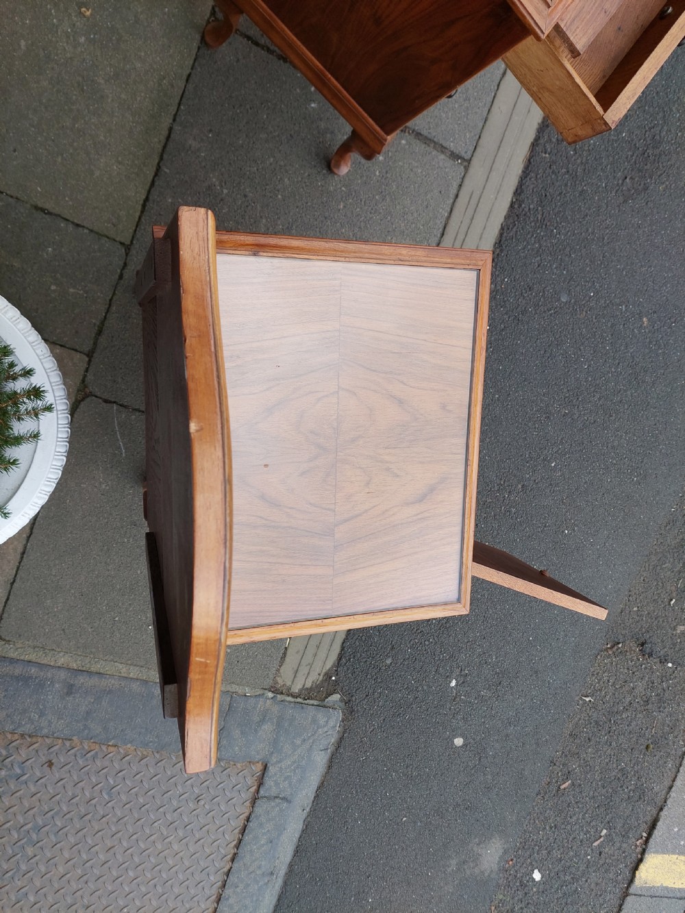 A matching pair of Art Deco figured walnut bedside cabinets with shaped upstands, single drawers, and lower cupboards on cabriole legs. View II