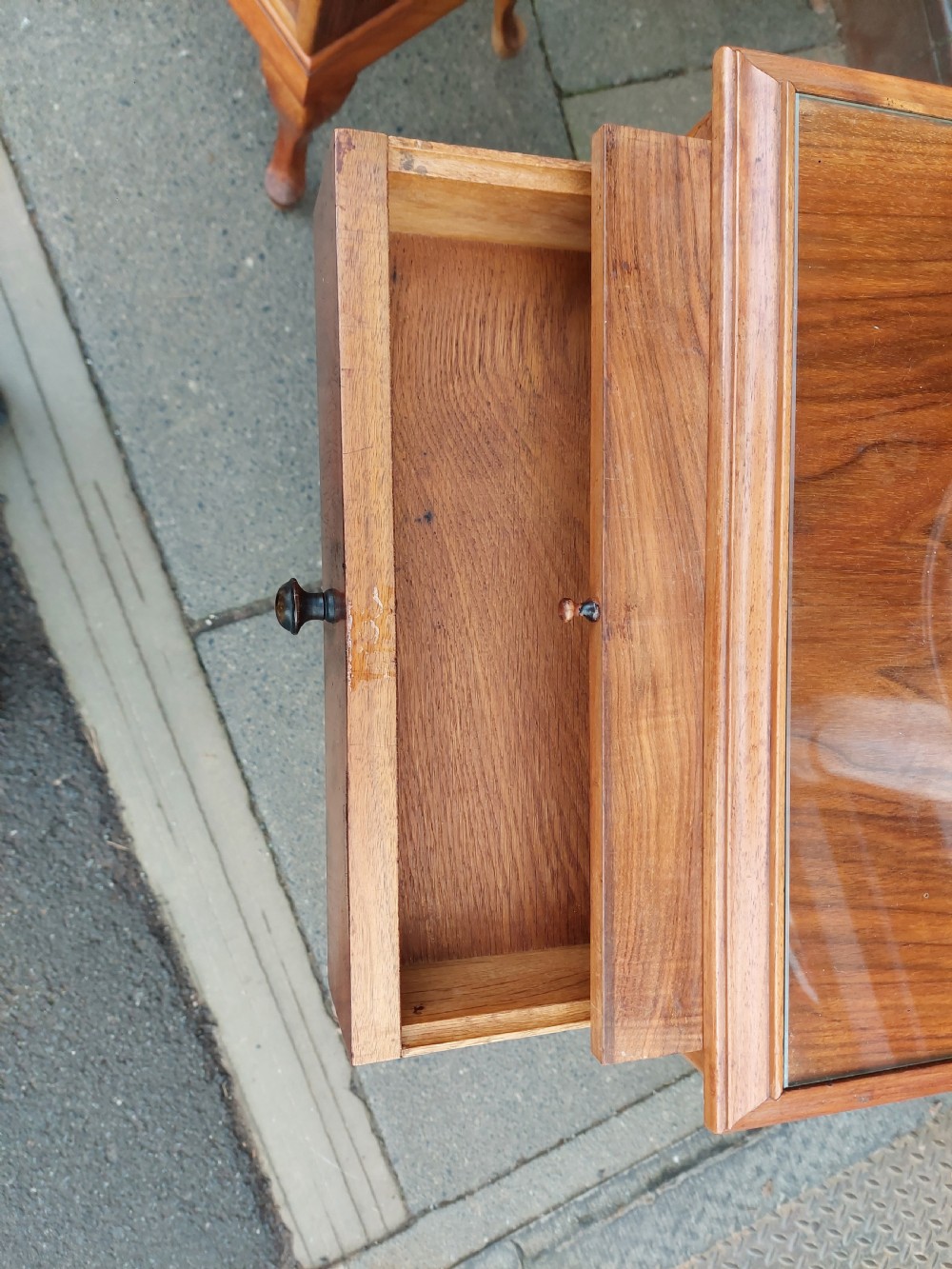 A matching pair of Art Deco figured walnut bedside cabinets with shaped upstands, single drawers, and lower cupboards on cabriole legs. View V