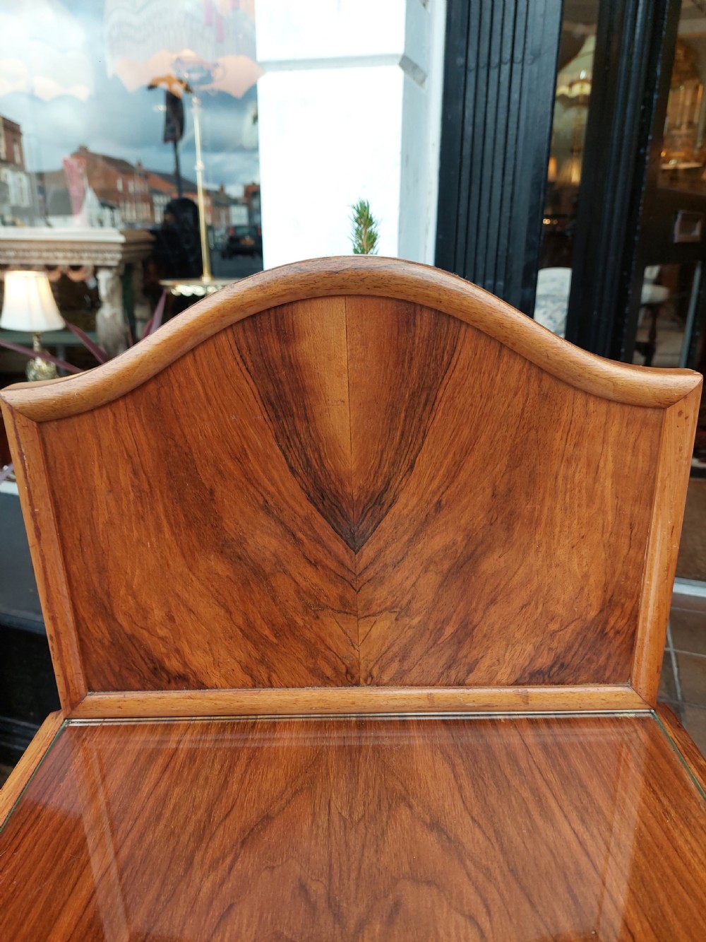 A matching pair of Art Deco figured walnut bedside cabinets with shaped upstands, single drawers, and lower cupboards on cabriole legs. View XI