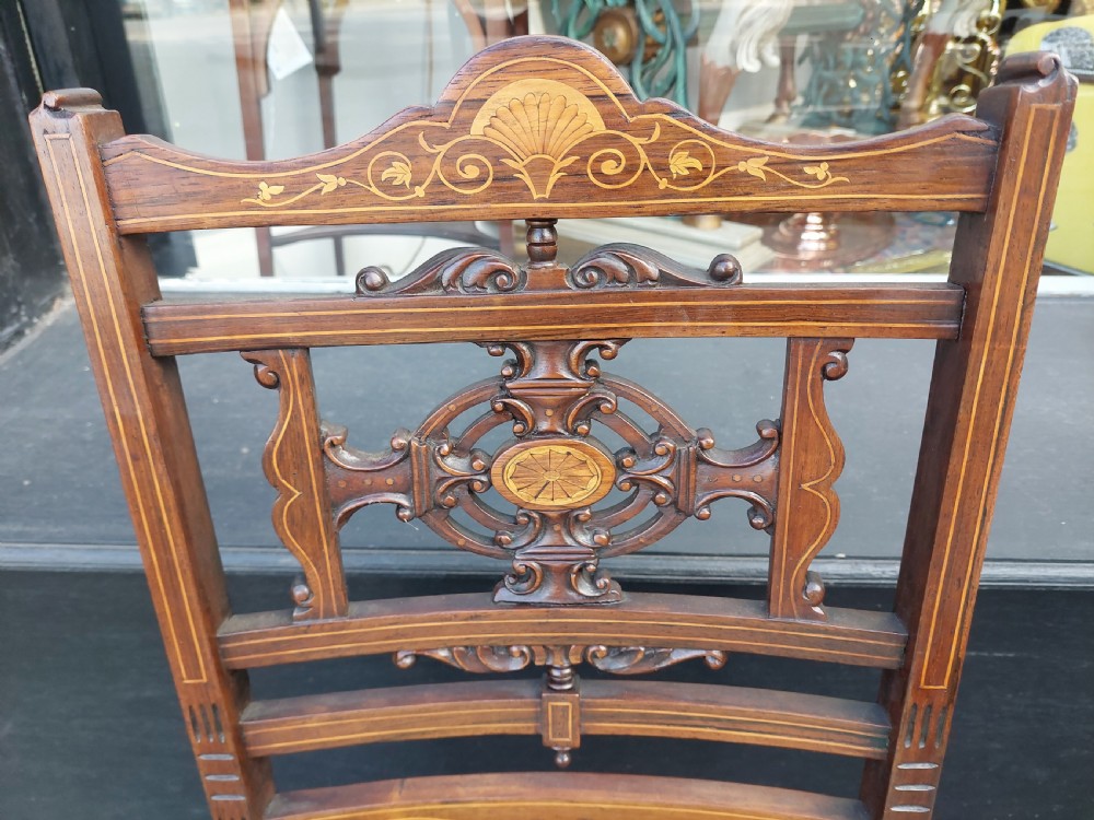 A pair of Edwardian rosewood salon chairs featuring intricate marquetry backrests, turned front legs, and bright teal velvet seat cushions. View III