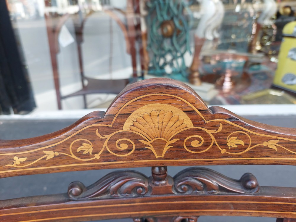 A pair of Edwardian rosewood salon chairs featuring intricate marquetry backrests, turned front legs, and bright teal velvet seat cushions. View IV