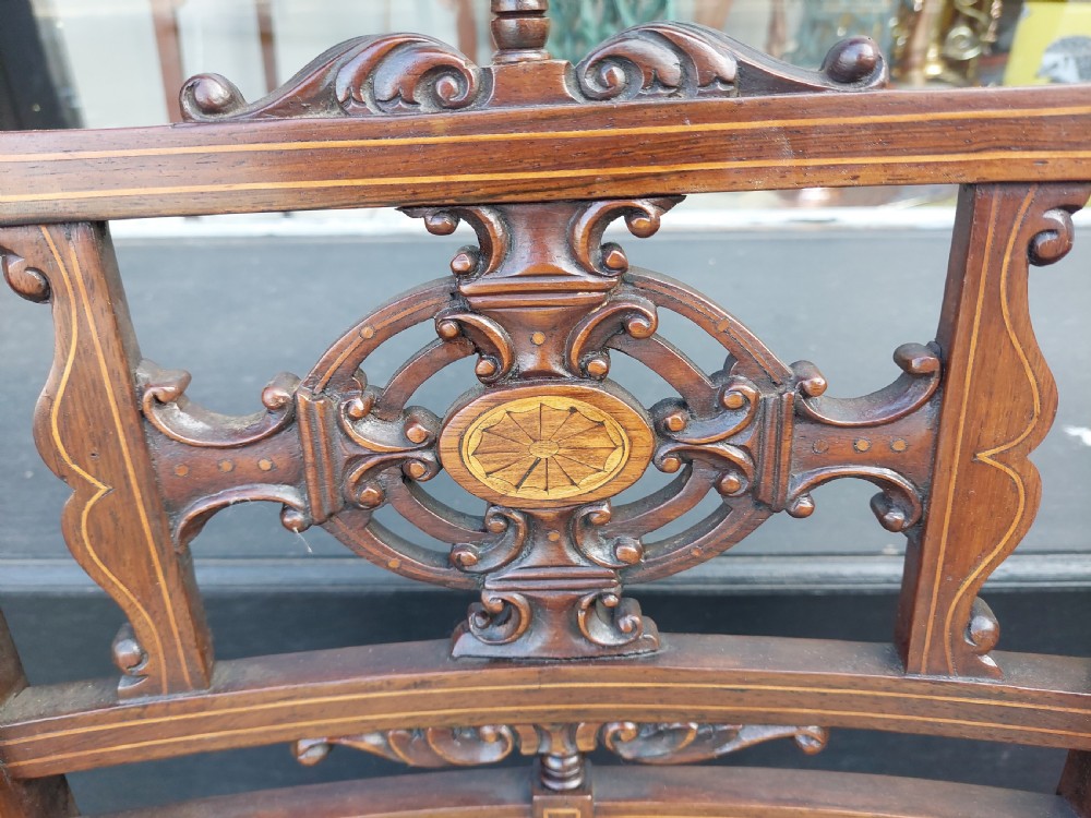 A pair of Edwardian rosewood salon chairs featuring intricate marquetry backrests, turned front legs, and bright teal velvet seat cushions. View V