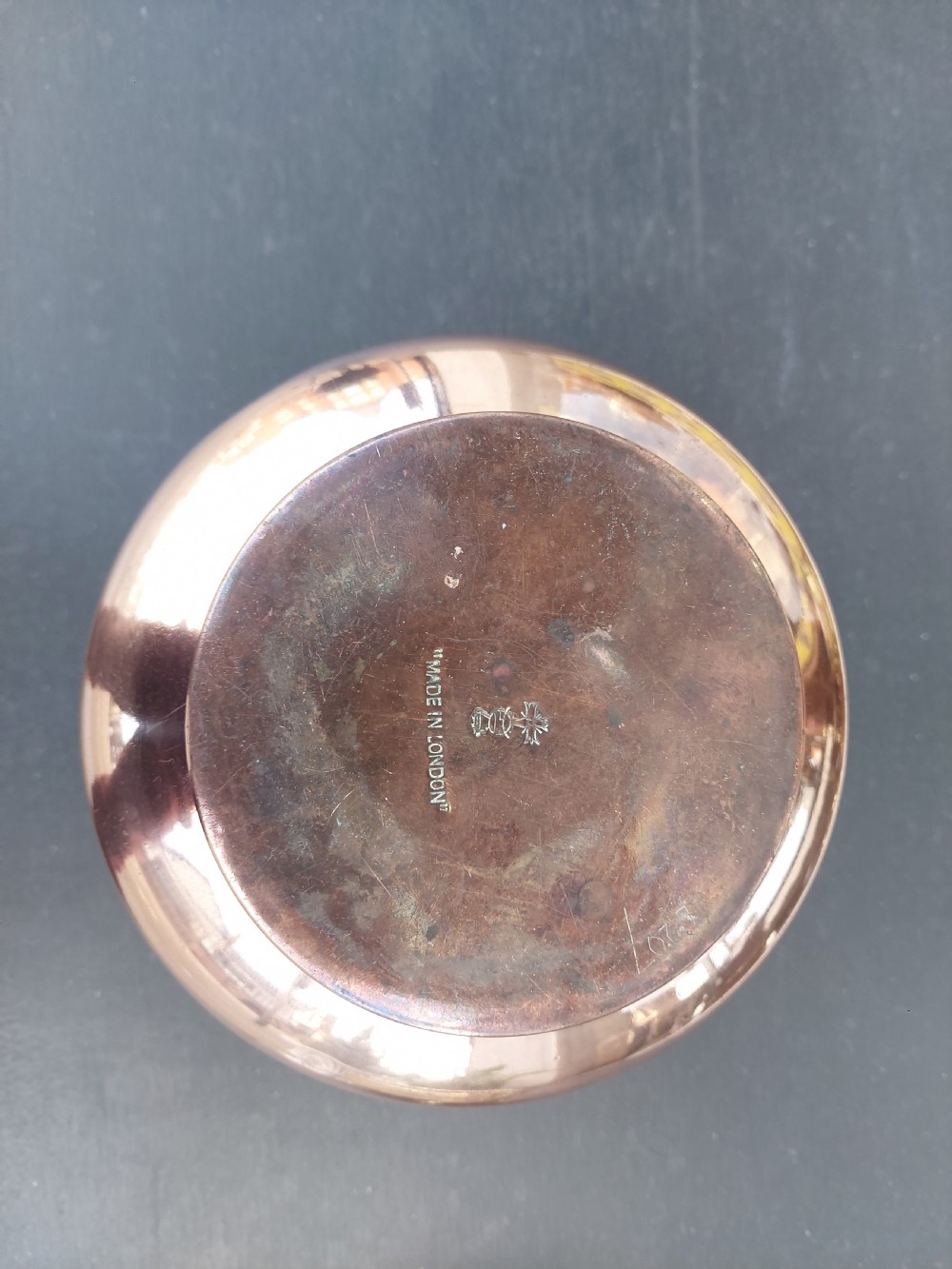 A late Victorian copper planter featuring embossed foliate designs around the rounded body and a flared rim. View III