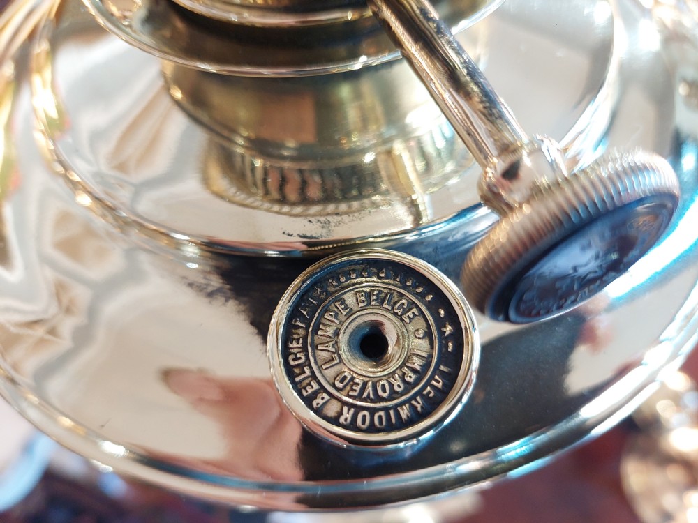 A late nineteenth-century Corinthian column oil lamp featuring a fluted stem, polished metal reservoir, and a white fabric dome shade trimmed with blue piping and long glass bead fringe. View XI