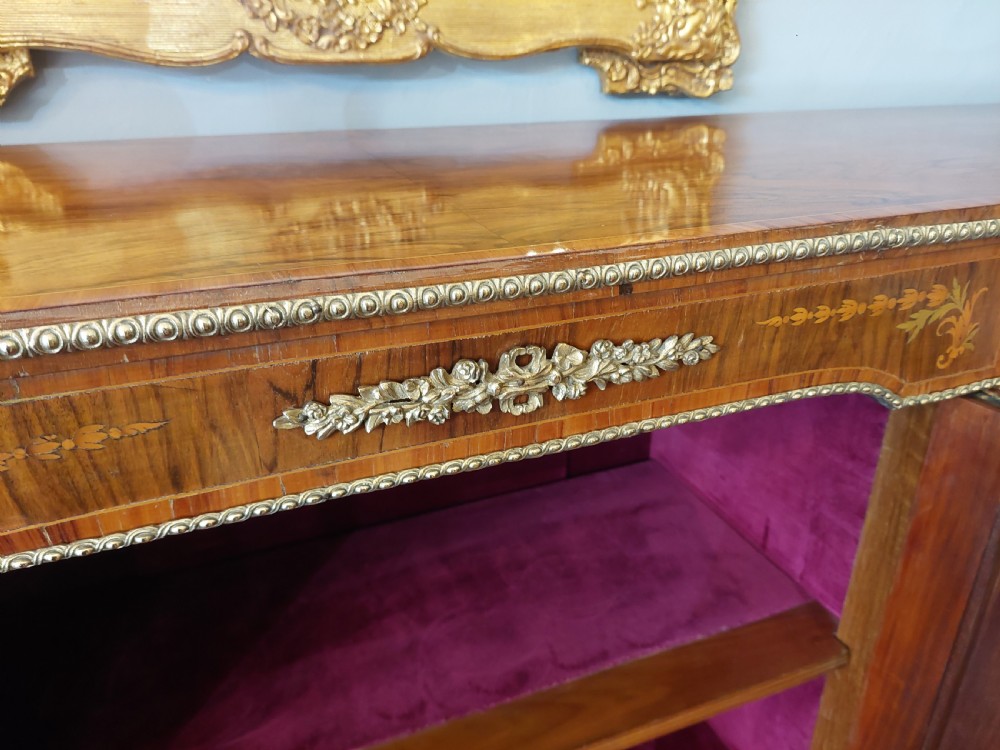 A nineteenth-century Victorian breakfront cabinet in burr walnut with marquetry inlay, gilt metal mounts, a central panelled door, and two side glazed display sections with velvet lining. View VII