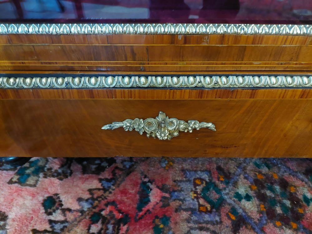 A nineteenth-century Victorian breakfront cabinet in burr walnut with marquetry inlay, gilt metal mounts, a central panelled door, and two side glazed display sections with velvet lining. View IX