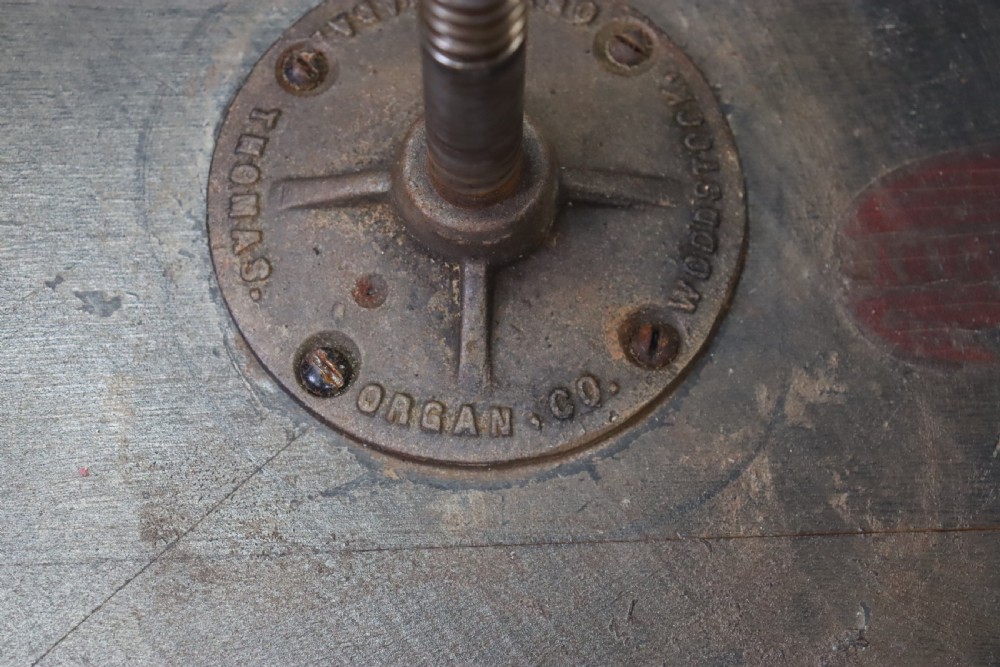 An early 20th-century dark mahogany piano stool featuring a circular swivel top, turned spindled legs, central pillar, and metal claw feet with glass balls. View X