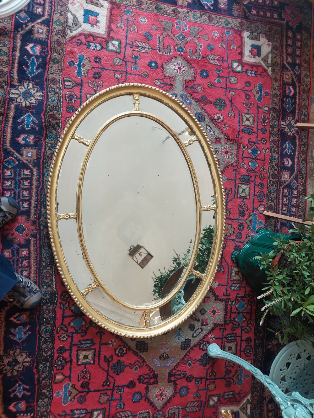 A late Victorian oval wall mirror featuring a gilded gesso frame with a rope-twist outer edge and an inner marginal glass border. View II