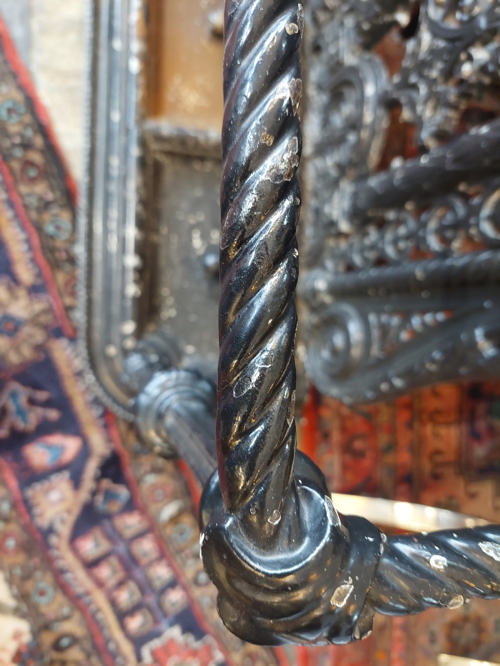 An ornate 19th-century black cast iron hall stand featuring coat hooks, intricate scrollwork, umbrella compartments, and a removable drip tray base. View IV