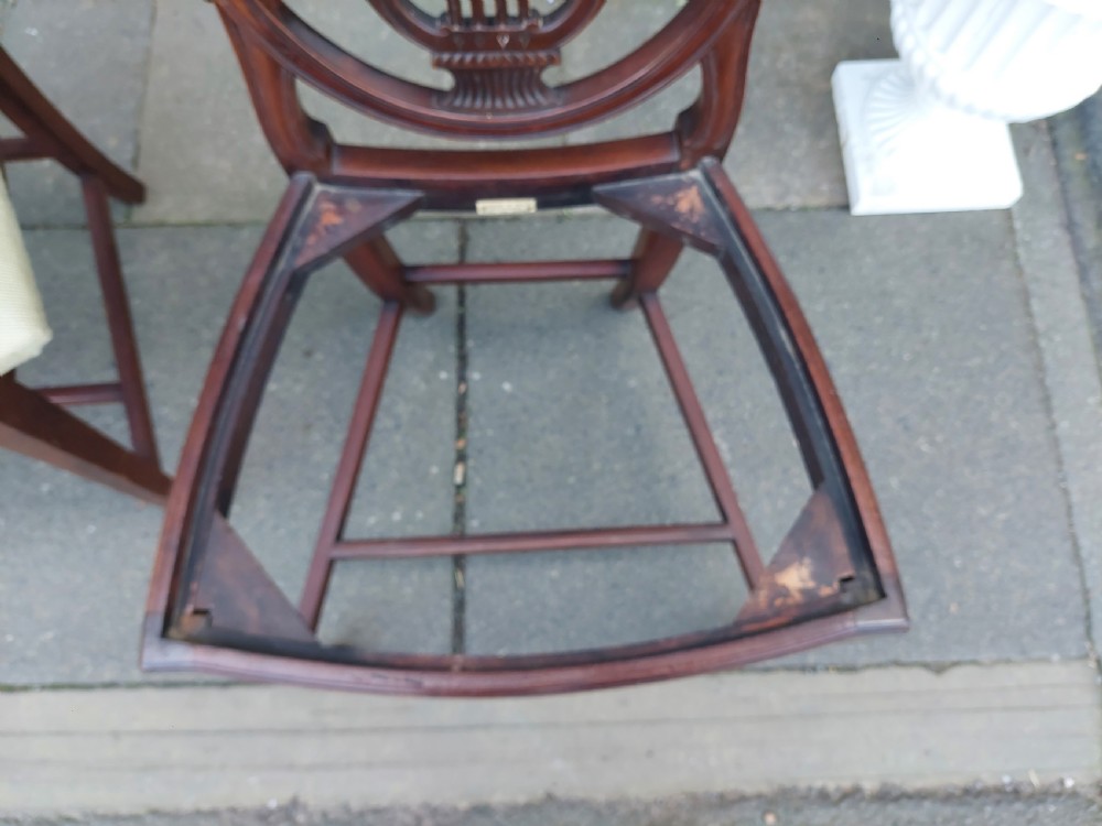 A set of six late nineteenth-century mahogany dining chairs featuring shield-shaped backs with carved lyre motifs and pale green upholstered seats. View VIII