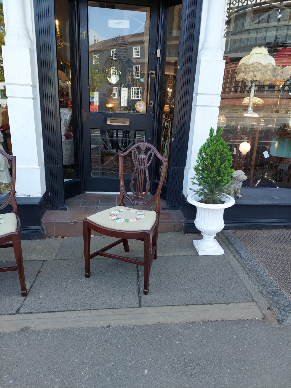 A set of six late nineteenth-century mahogany dining chairs featuring shield-shaped backs with carved lyre motifs and pale green upholstered seats. View XI