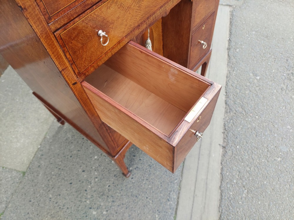 A late 19th-century George II style mahogany kneehole desk featuring herringbone inlay, brass drop handles, and a central recessed cupboard. View III