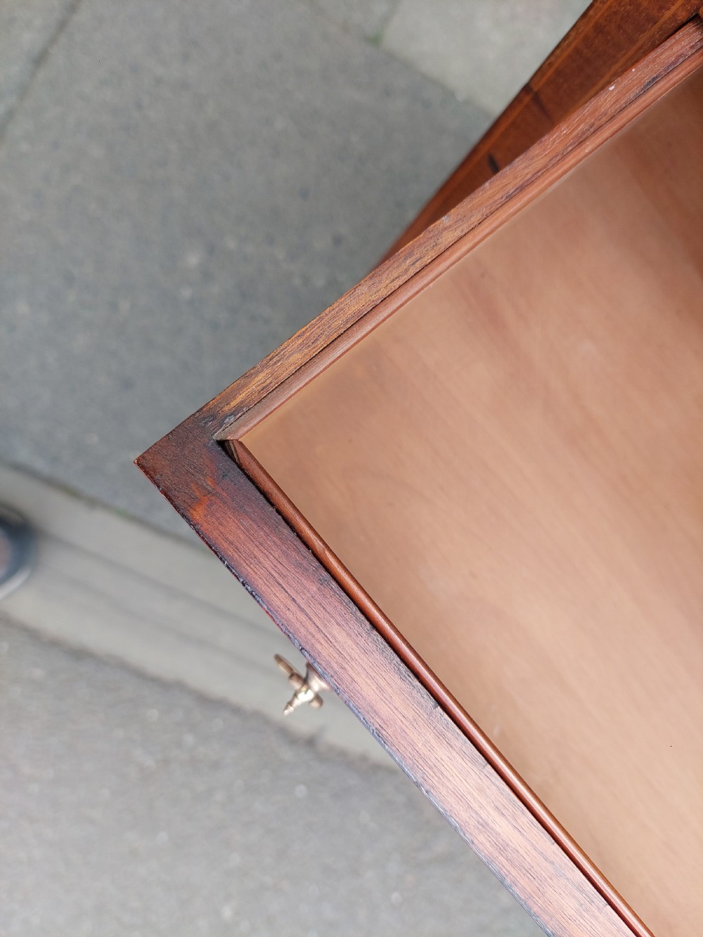 A late 19th-century George II style mahogany kneehole desk featuring herringbone inlay, brass drop handles, and a central recessed cupboard. View V