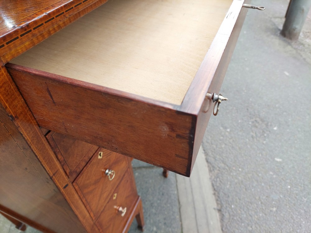 A late 19th-century George II style mahogany kneehole desk featuring herringbone inlay, brass drop handles, and a central recessed cupboard. View VII