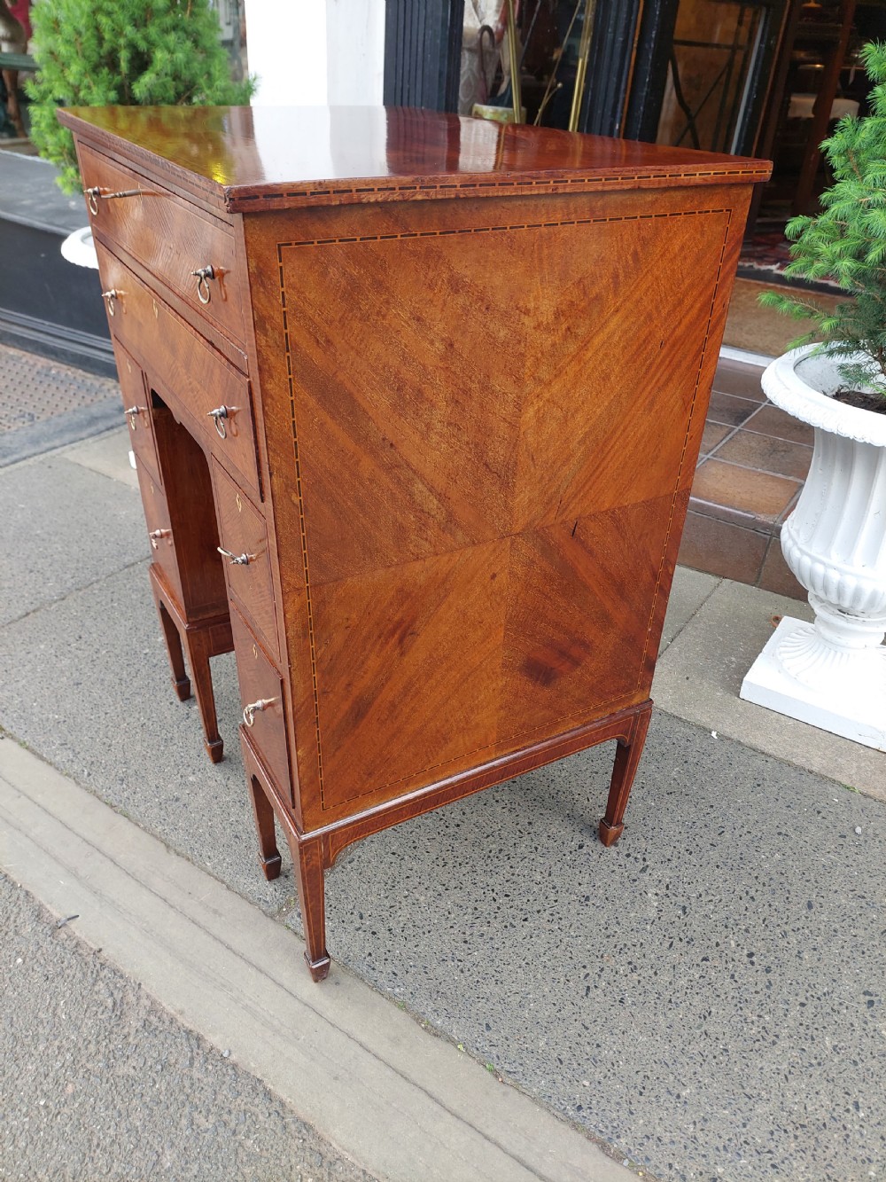 A late 19th-century George II style mahogany kneehole desk featuring herringbone inlay, brass drop handles, and a central recessed cupboard. View IX