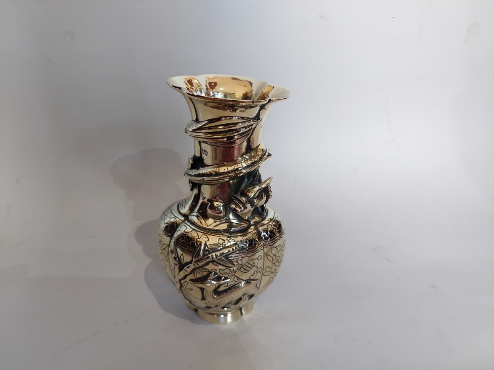 An early 20th-century Chinese brass vase featuring high-relief dragon and fauna ornamentation with a flared scalloped rim. View III