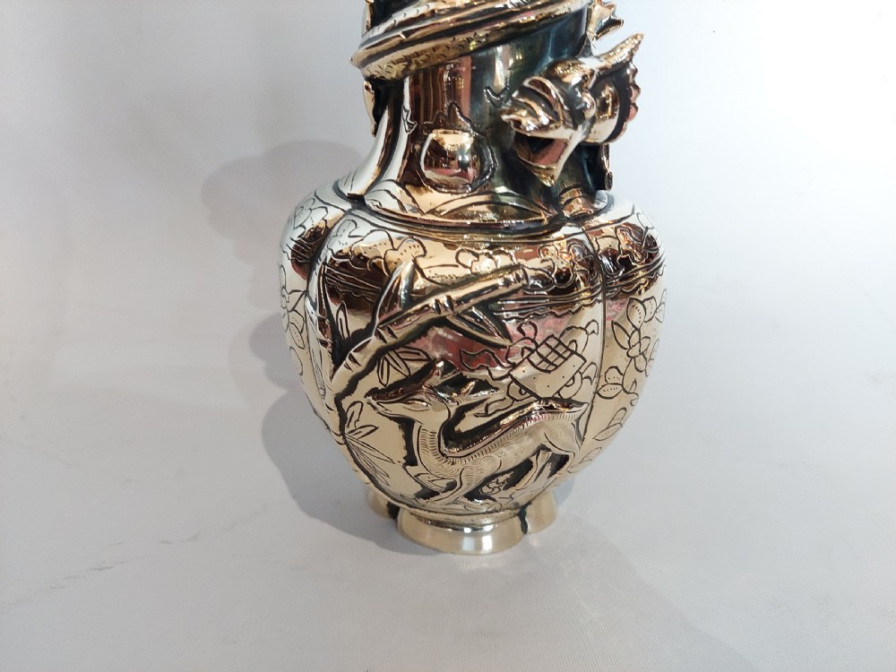 An early 20th-century Chinese brass vase featuring high-relief dragon and fauna ornamentation with a flared scalloped rim. View IV