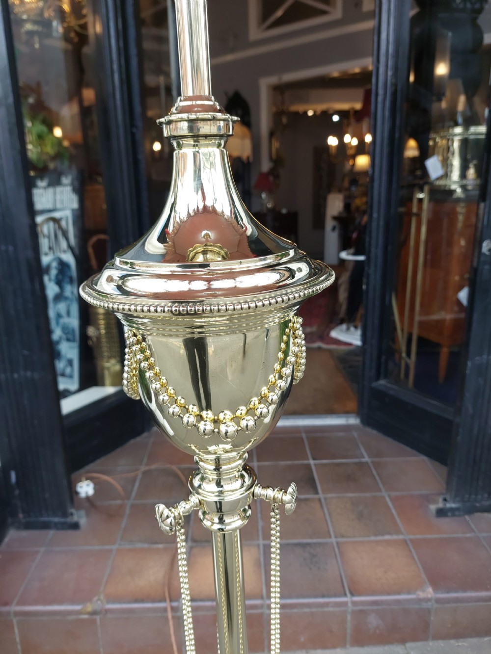 A late nineteenth-century brass standard floor lamp featuring a polished metal column with decorative swags and an ornate pink fabric shade with tassel fringe. View III