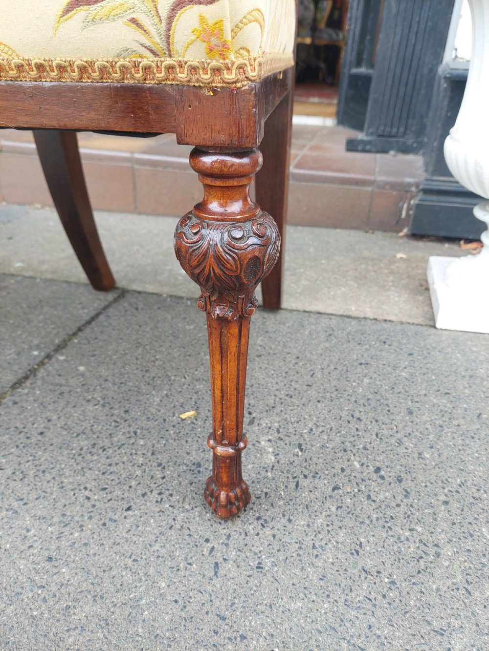 A pair of nineteenth-century carved walnut side chairs featuring openwork scrollwork backrests, turned legs, and cream floral pattern upholstery. View VII