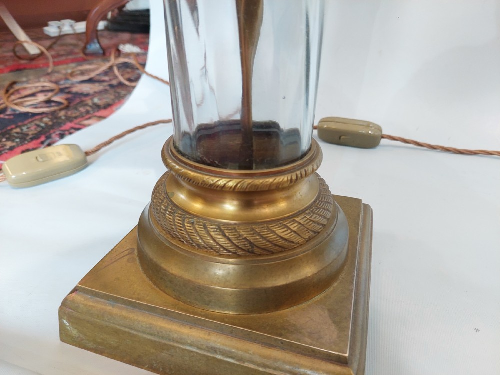 A pair of early 20th-century table lamps with square brass bases, twisted clear glass columns, and drum lampshades featuring countryside wildlife illustrations. View III