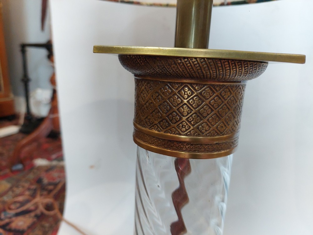 A pair of early 20th-century table lamps with square brass bases, twisted clear glass columns, and drum lampshades featuring countryside wildlife illustrations. View IV