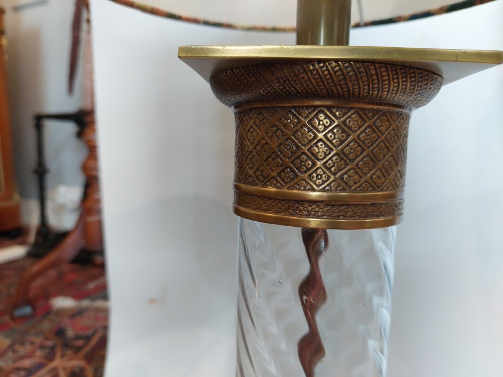 A pair of early 20th-century table lamps with square brass bases, twisted clear glass columns, and drum lampshades featuring countryside wildlife illustrations. View V