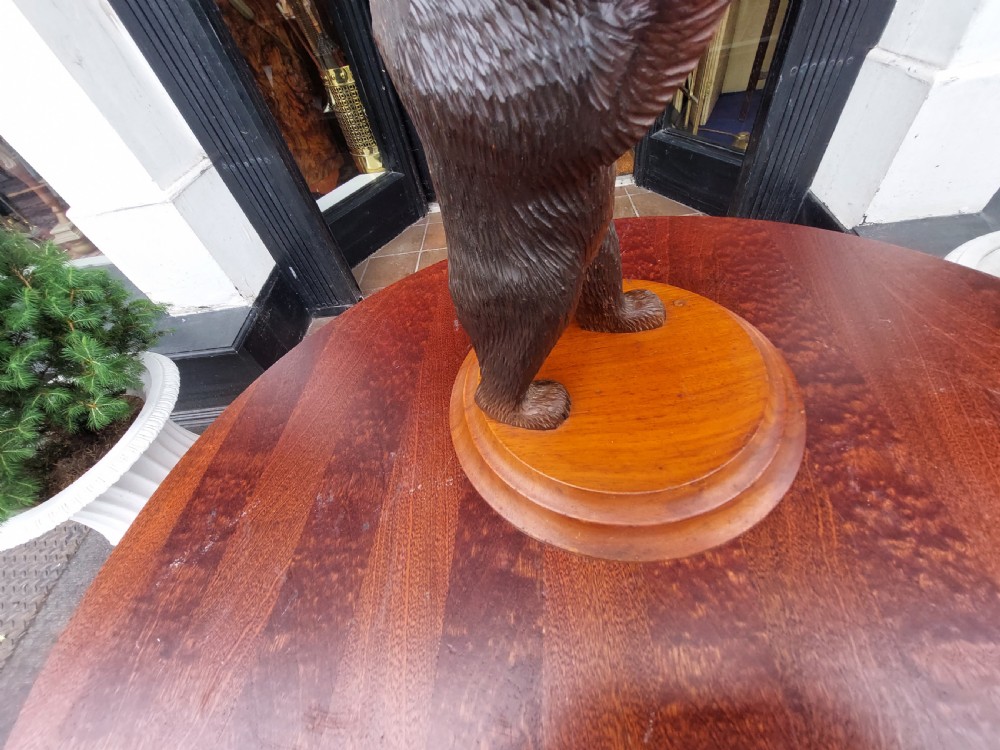 An early twentieth-century carved lindenwood Black Forest bear table lamp topped with a blue tartan fabric lampshade. View IV